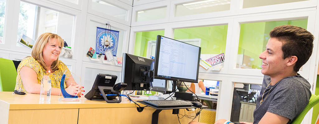 Lynn student meeting with an administrator in an office