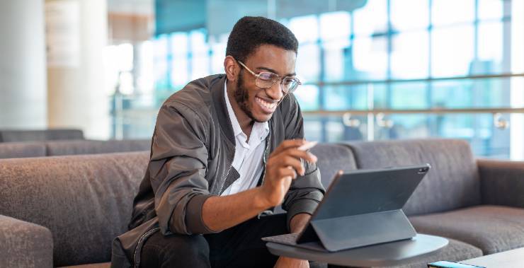 A college student studying on his tablet.