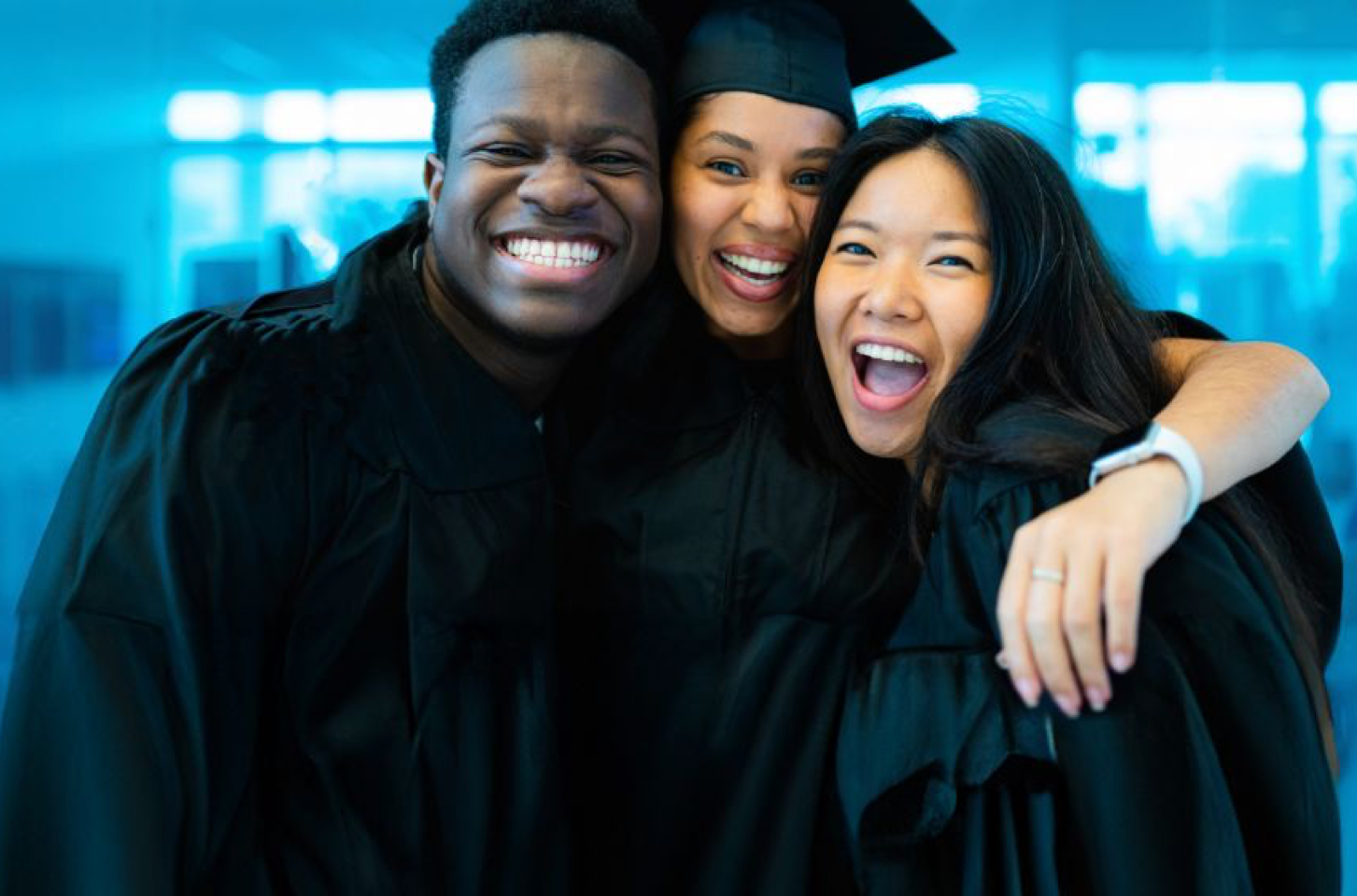 Group of graduates hugging