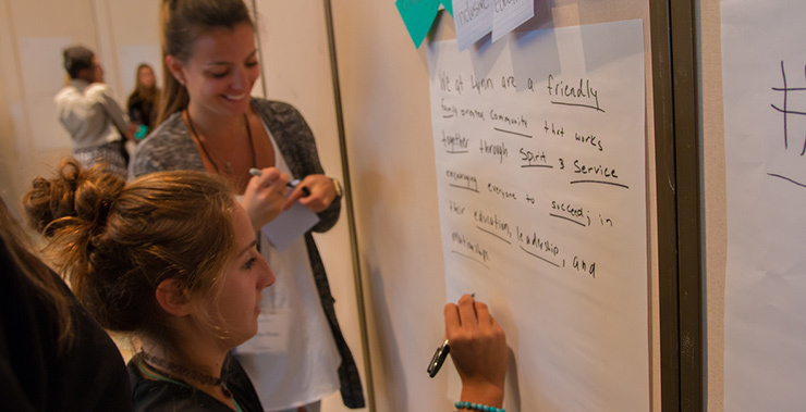 Two females conducting a writing exercise.