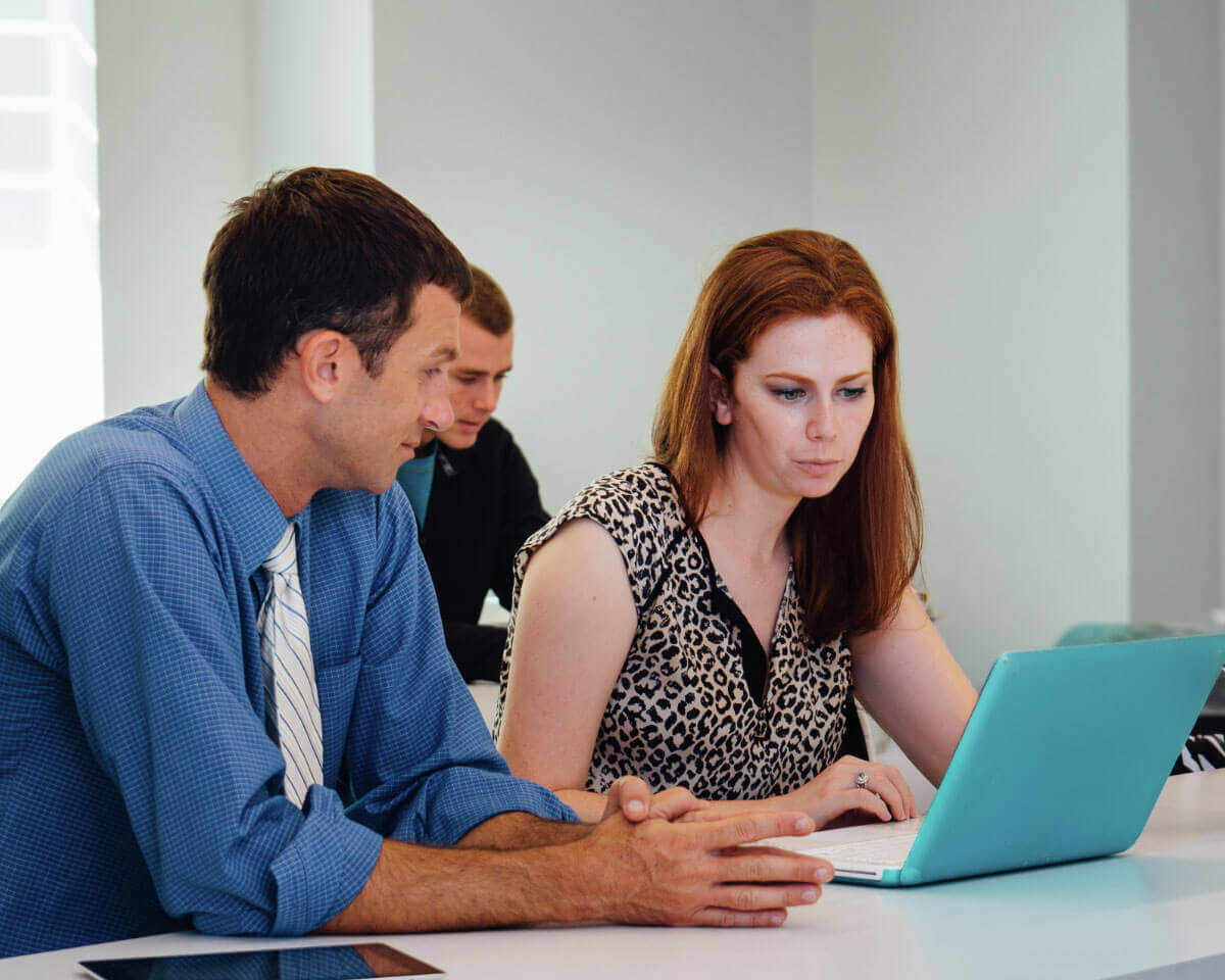 Lynn healthcare students review information on a laptop in a classroom