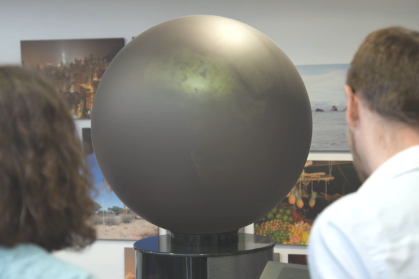 two people looking at a large globe 