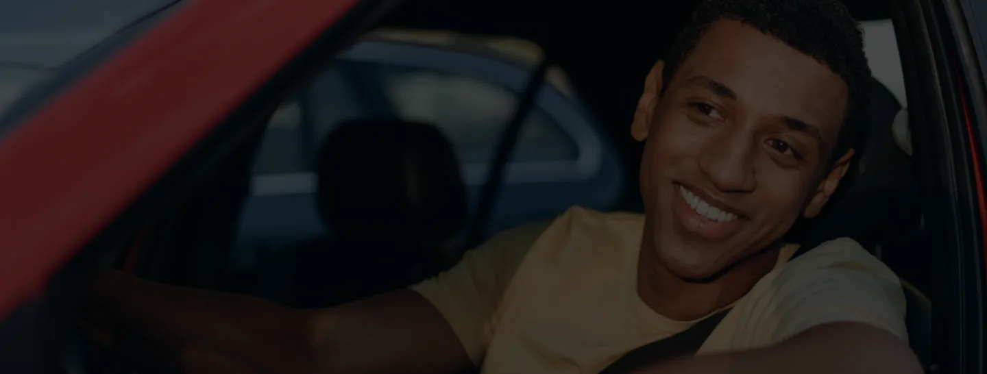 horizontal-view-young-multiracial-man-smiling-while-sitting-car-driver-place-driving-car-traffic-jam-road-trip-concept