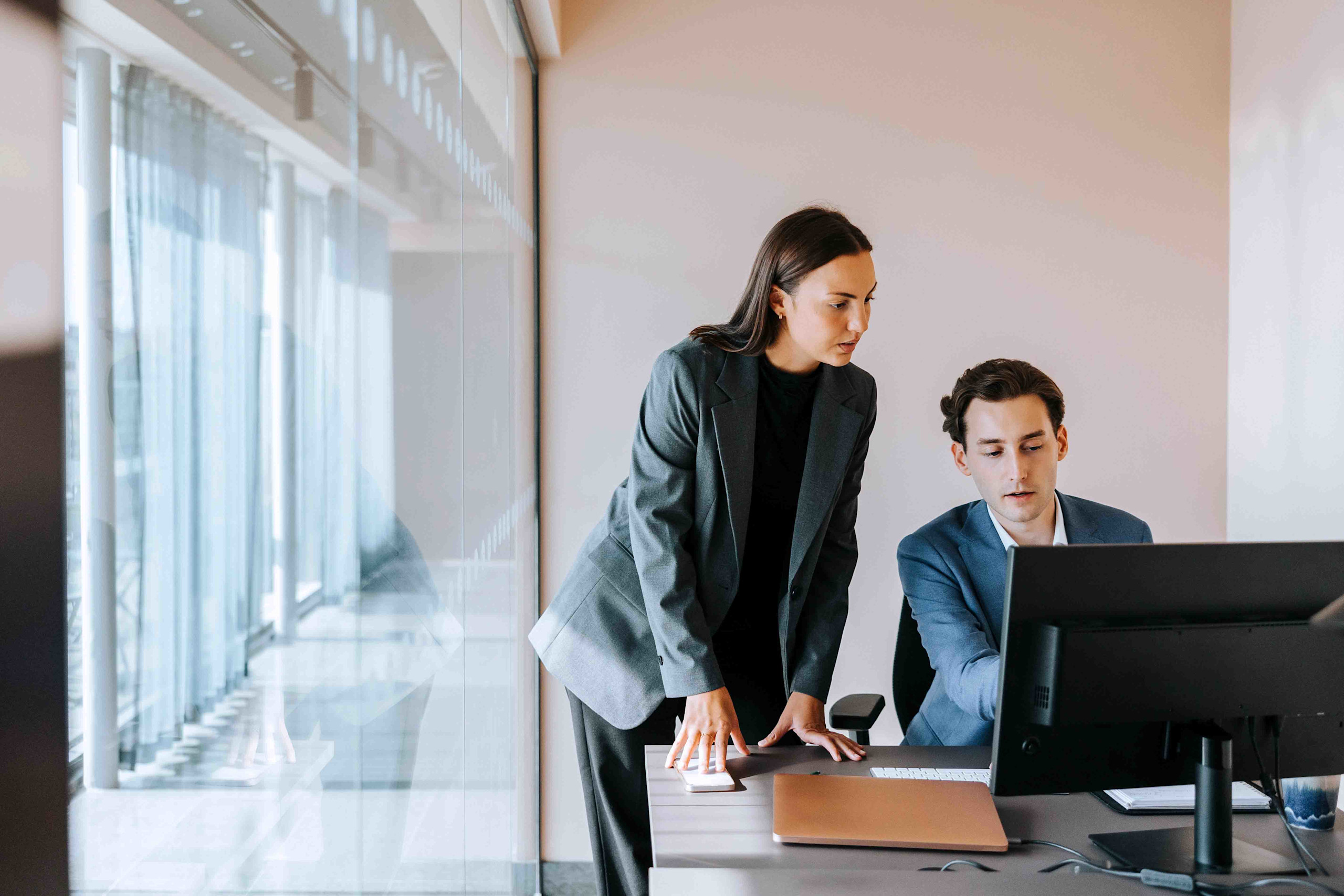 man and woman discuss trade spend accruals on trade promotion management software resized