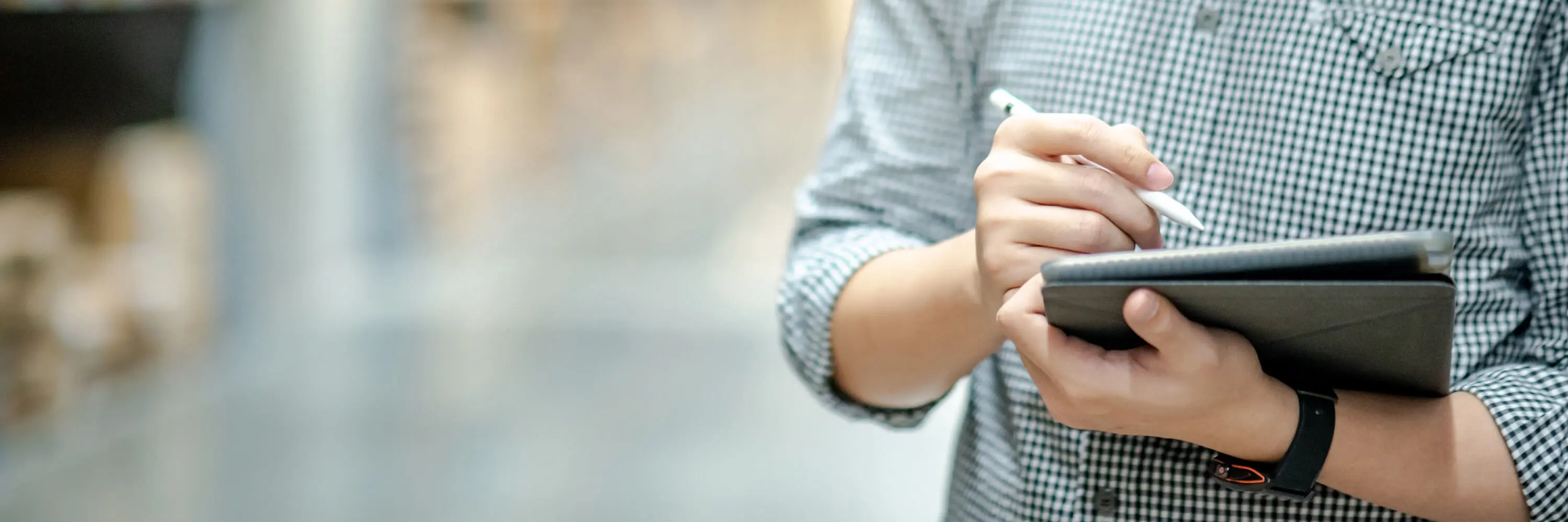 A person holding a notebook and a pen.