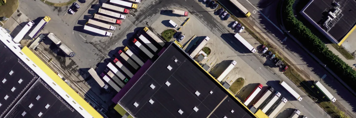 An aerial view of a parking lot with parked cars.