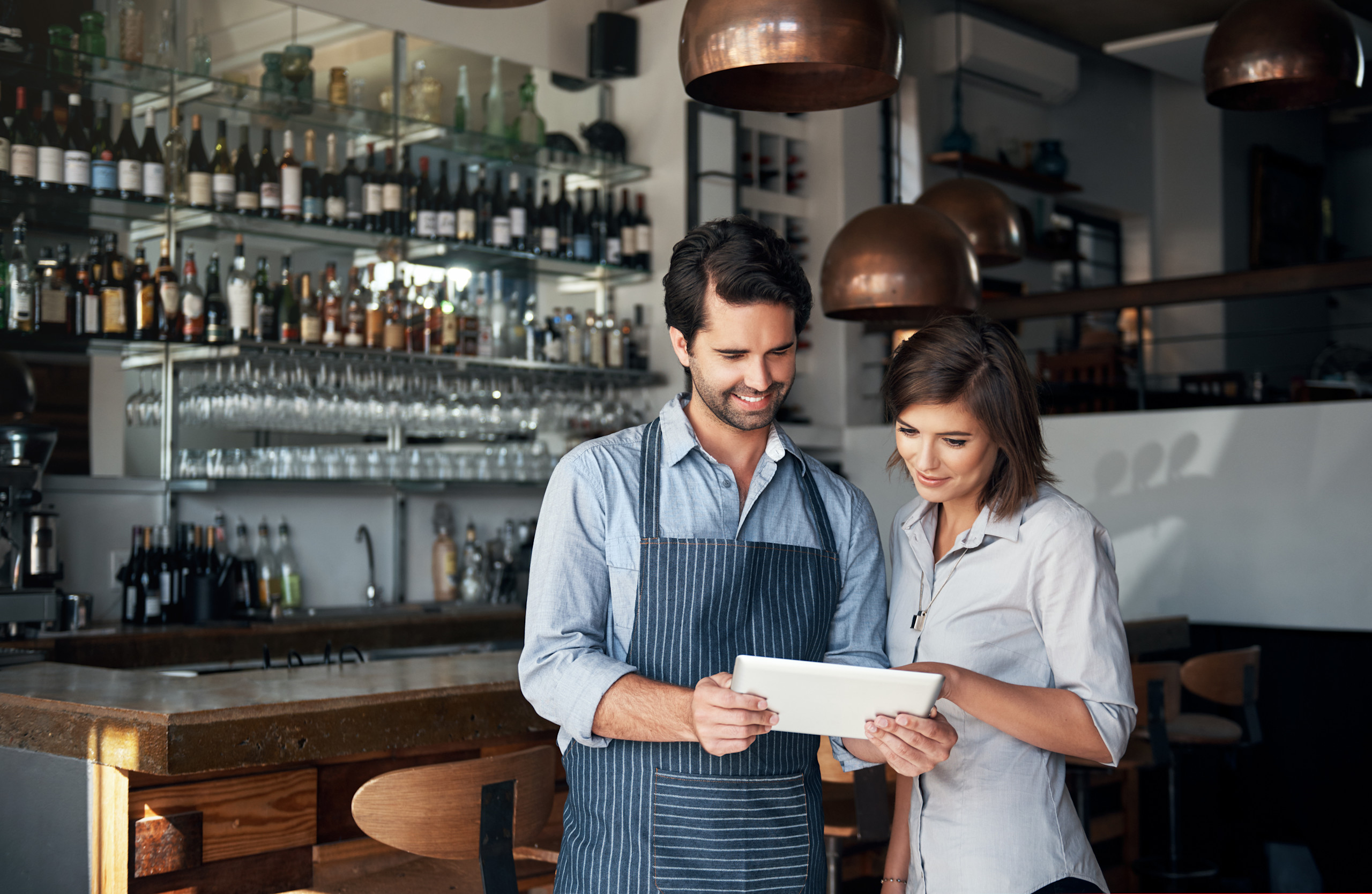 A restaurant operator reviews menu team member.