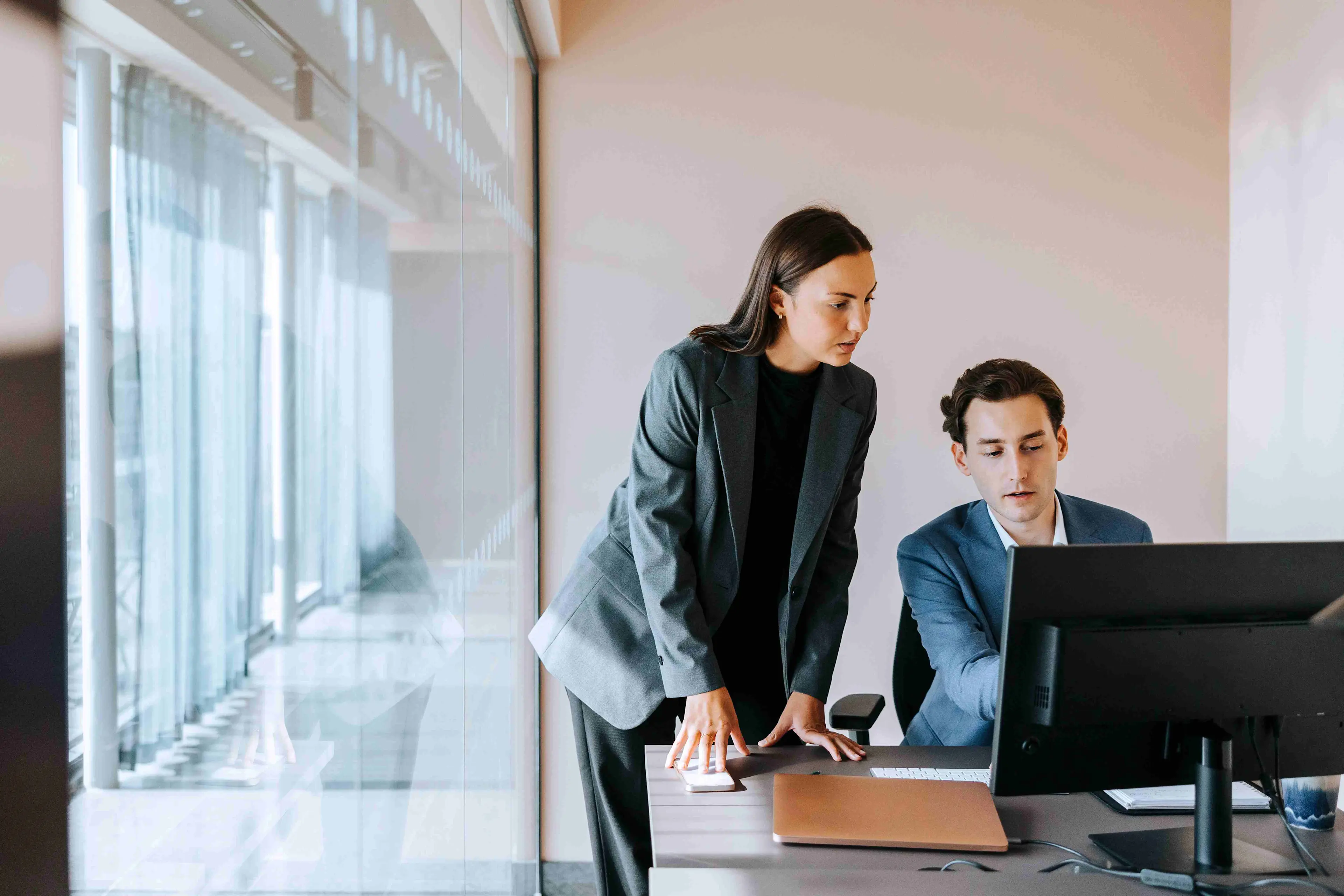 Two colleagues analyzing data on a tablet to support cpg cogs optimization efforts.