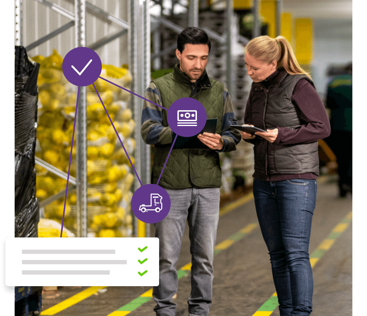 Two people in a warehouse looking at a tablet.