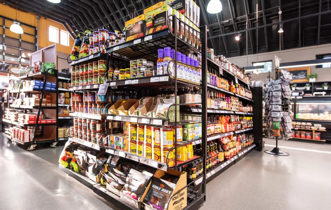 The aisles of a grocery store are filled with different types of food.