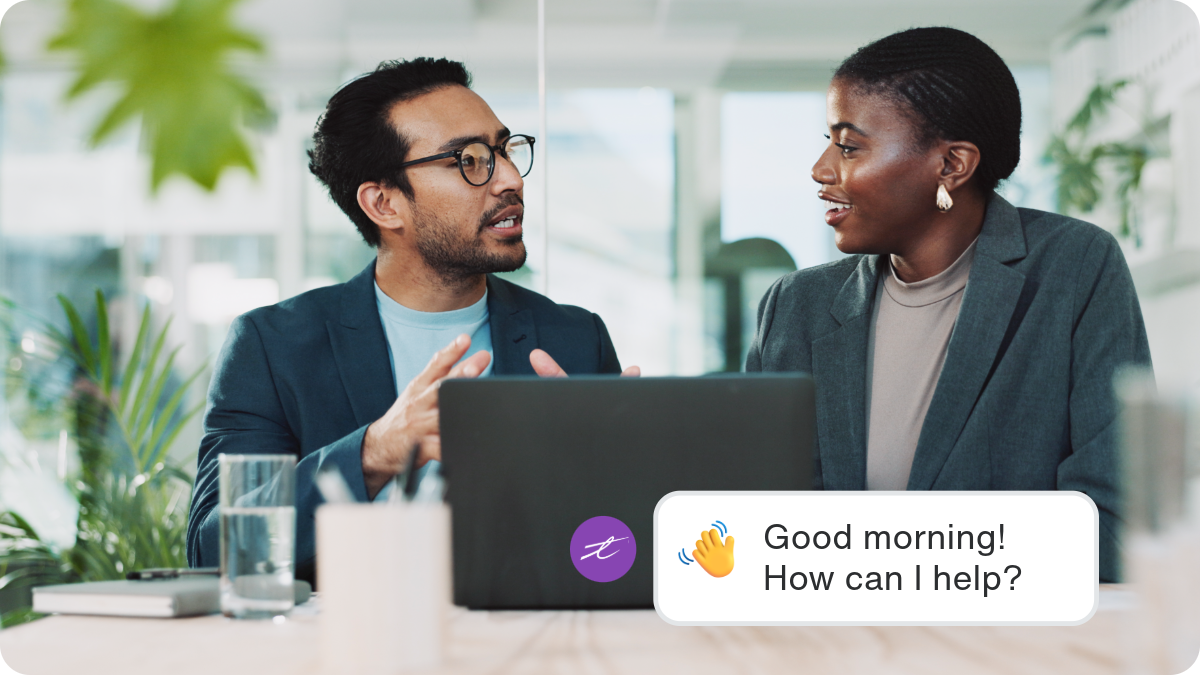A man and a woman using the AI Assistant in their morning workflow in an office environment.