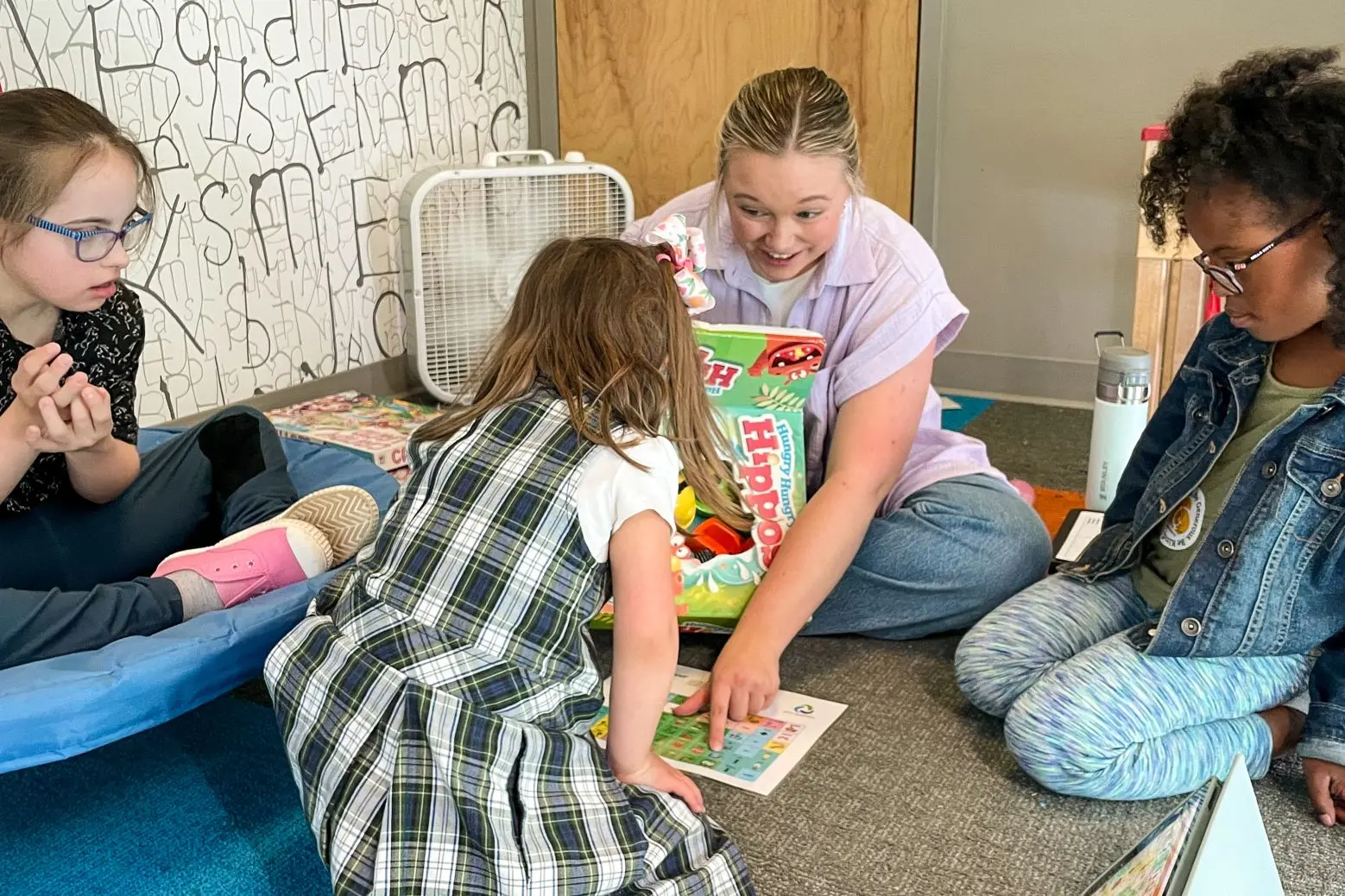 Four children engaging in a group program offered at GiGi’s Playhouse.