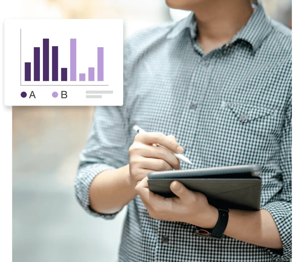 A man holding a tablet with a bar graph on it.