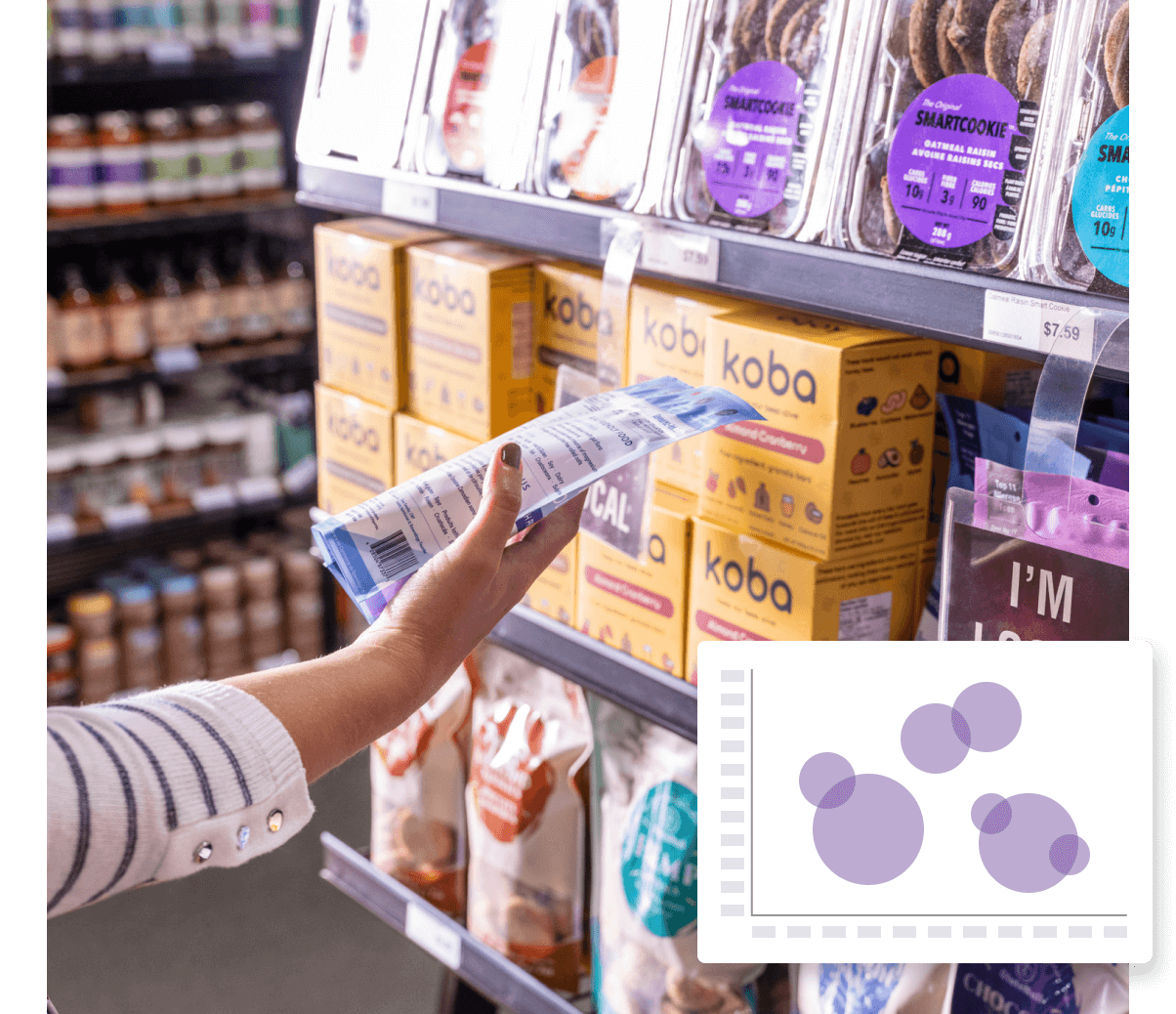 A woman picking up a box of cookies in a store.