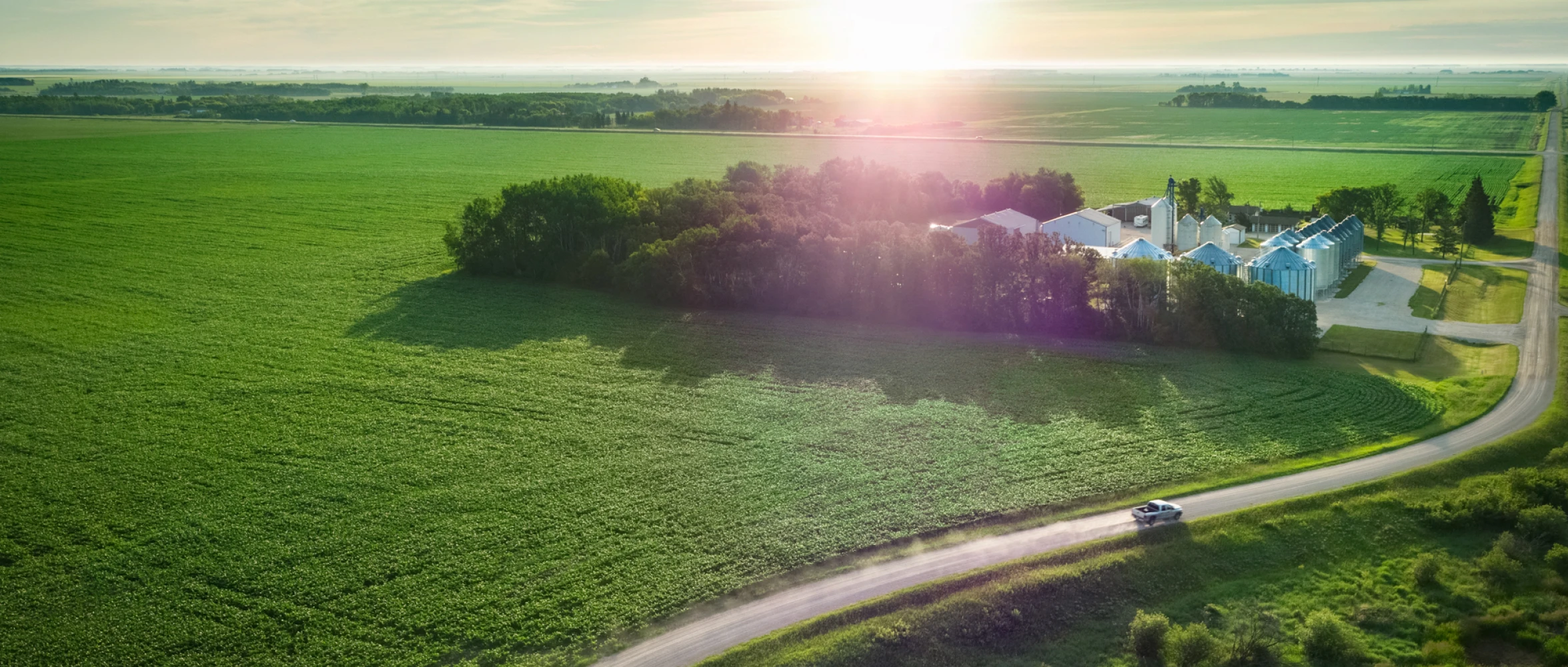 An aerial view of a farm and silos