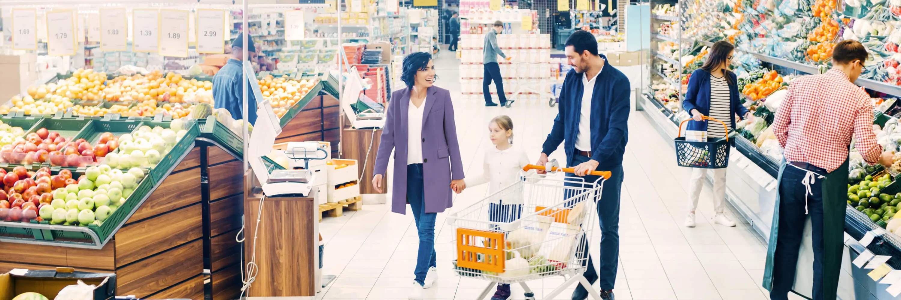 A group of people shopping in a grocery store.