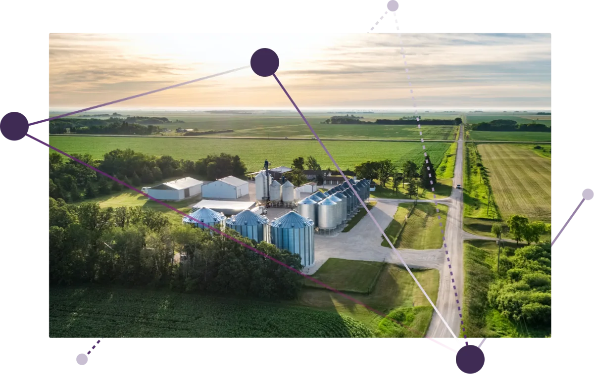 An aerial view of a farm and silos