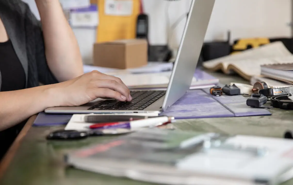 A woman typing on a laptop