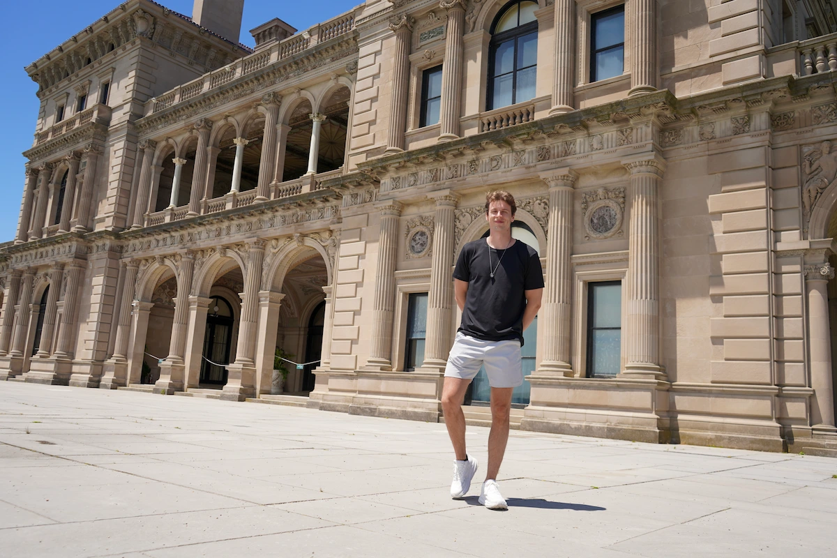Bru standing in front of an arched building in Providence
