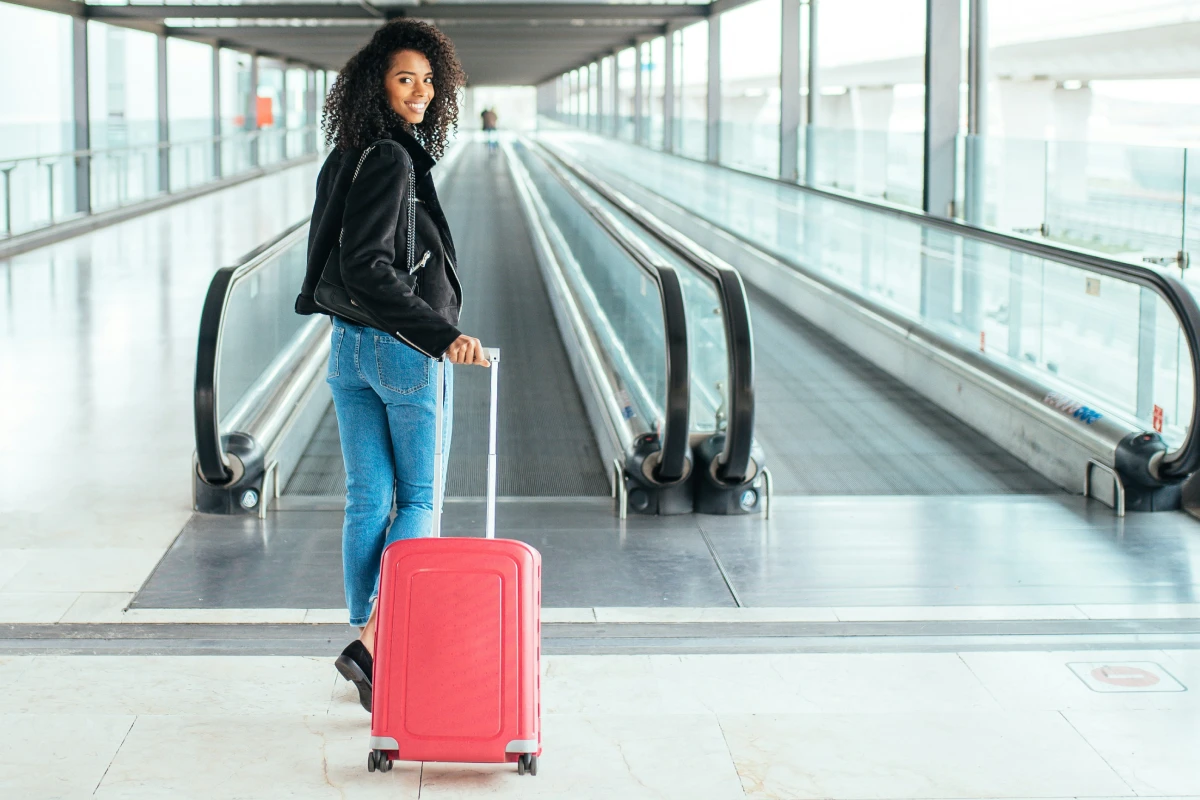 Traveler with a suitcase heading through the airport