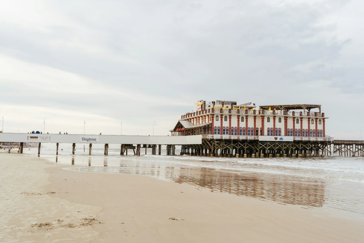 A large building on a pier over the ocean