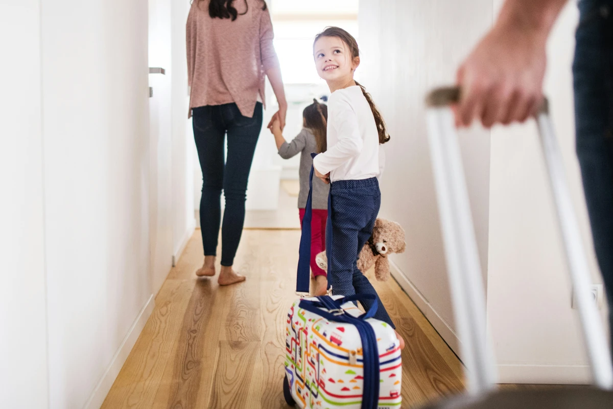 A family leaving home for a trip with luggage