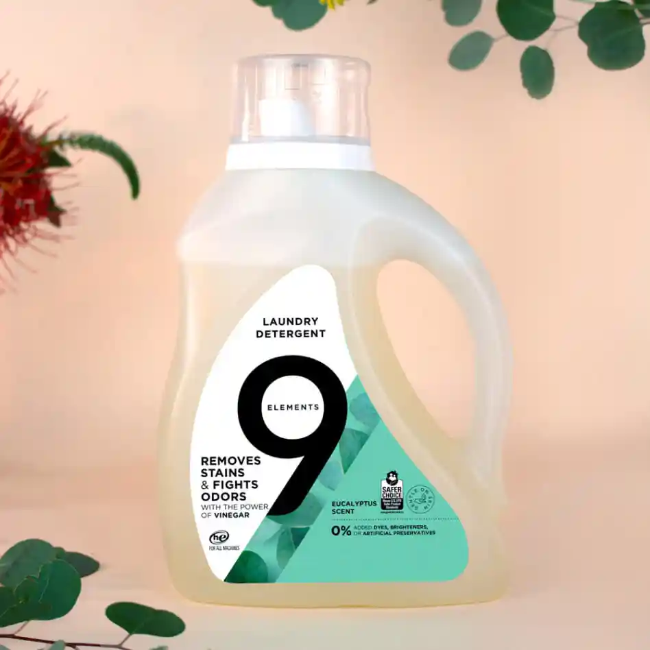 9 Elements eucalyptus laundry detergent bottle with flowers and citruses around