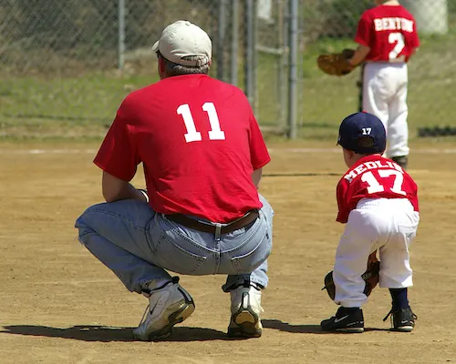 a player learning baseball from a coach