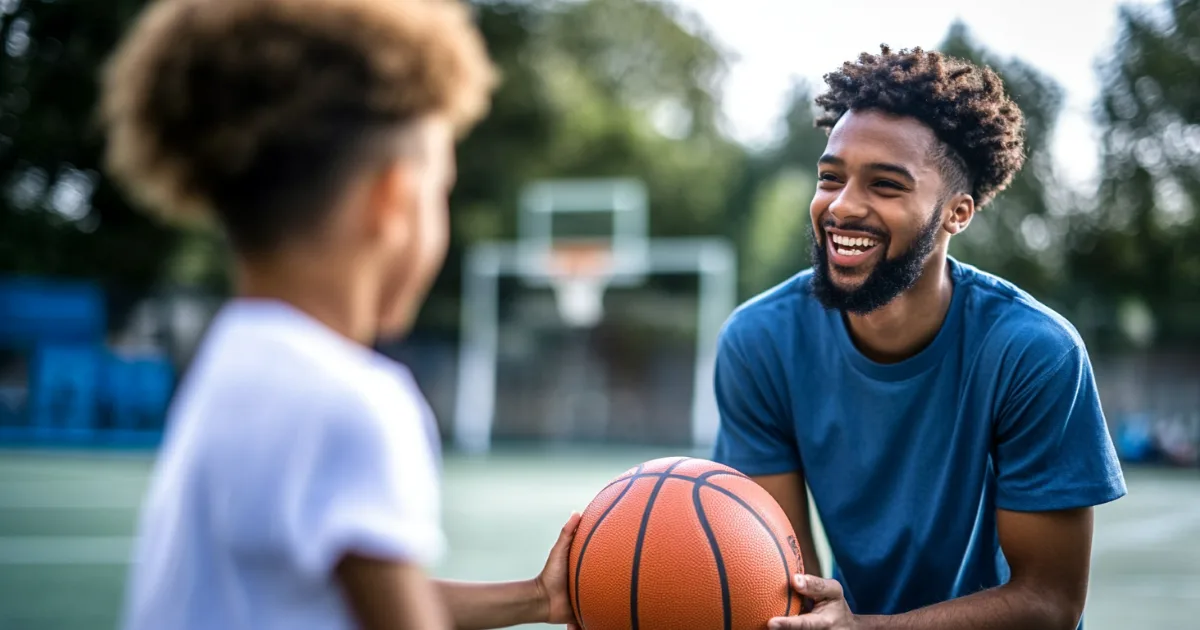 Youth sport volunteer coach with a youth athlete