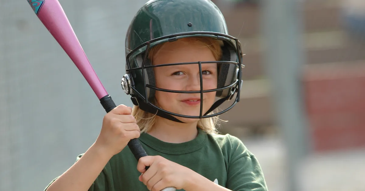 featured image for a blog post of a youth softball player