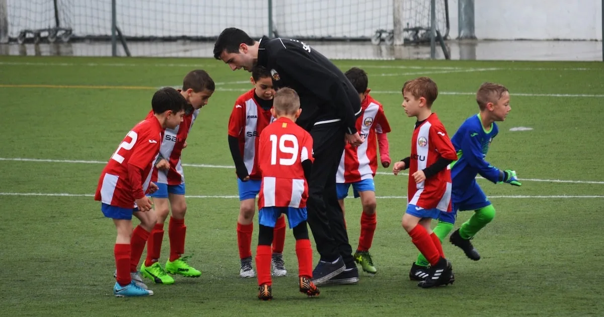 a youth soccer coach communicating with his team