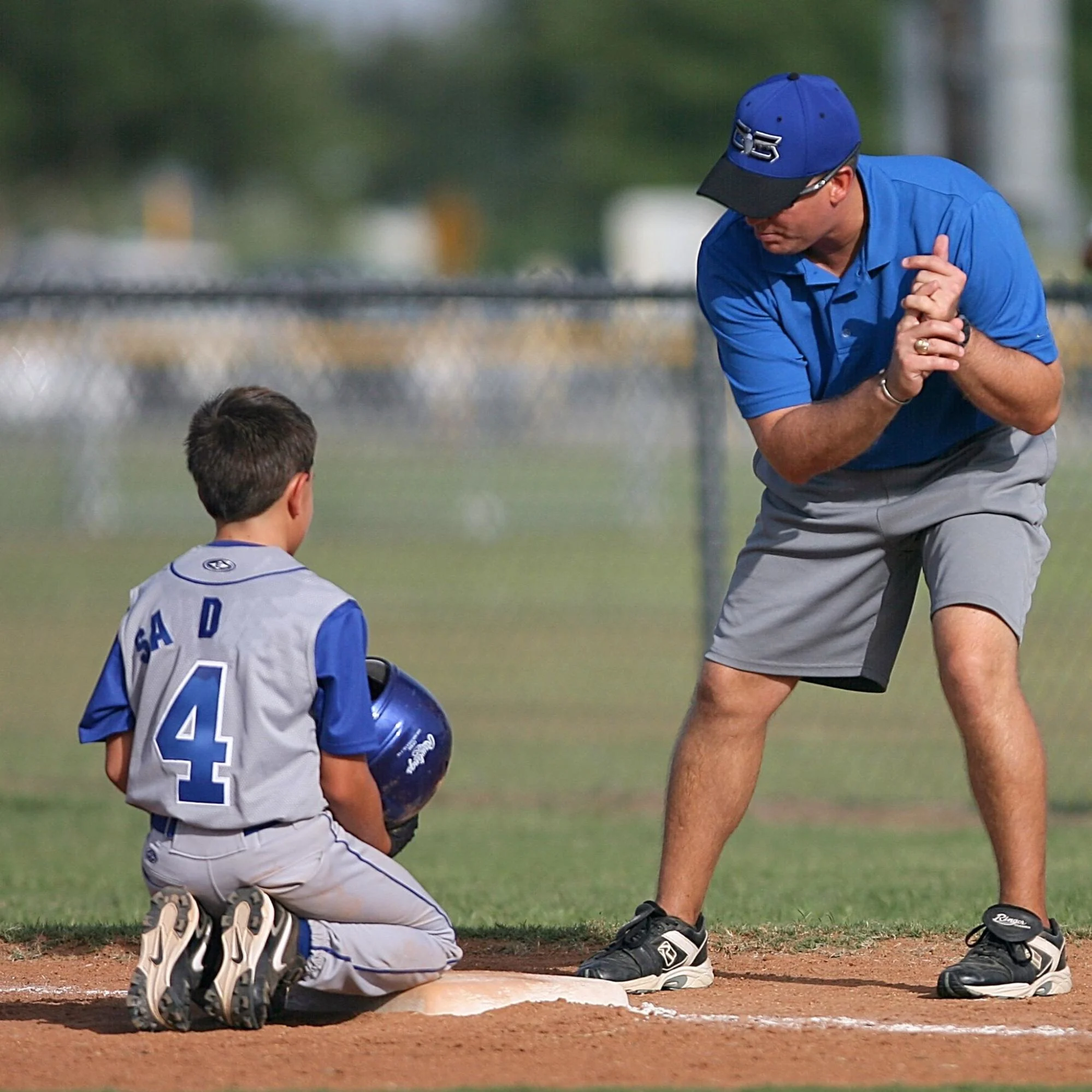 a youth baseball player learning from his coach
