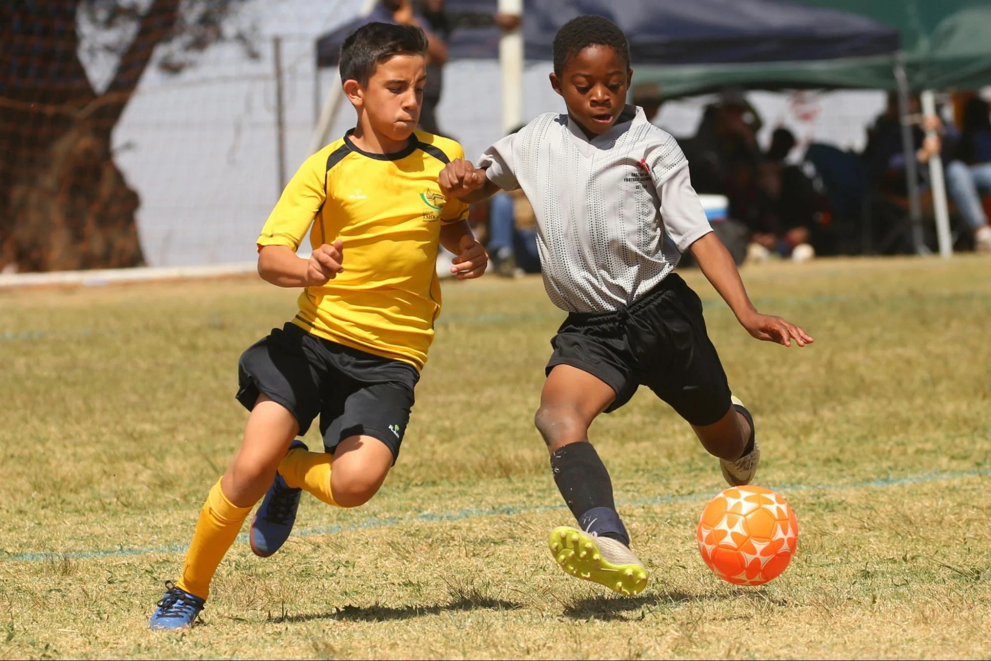 youth soccer players challenging for the ball