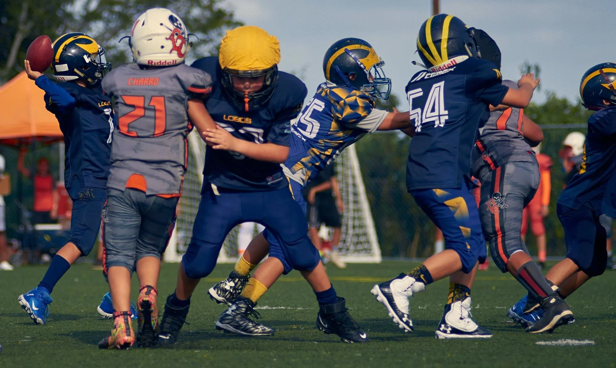 a youth football player passing the ball