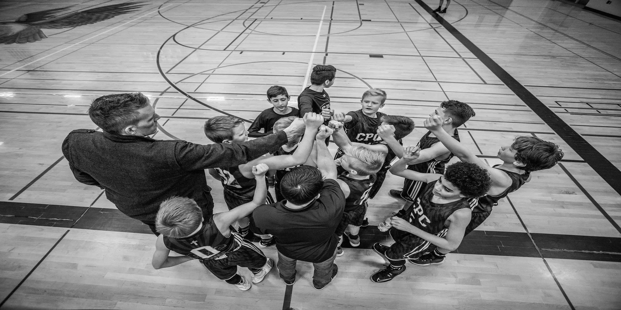 a coach communicating with his youth basketball players