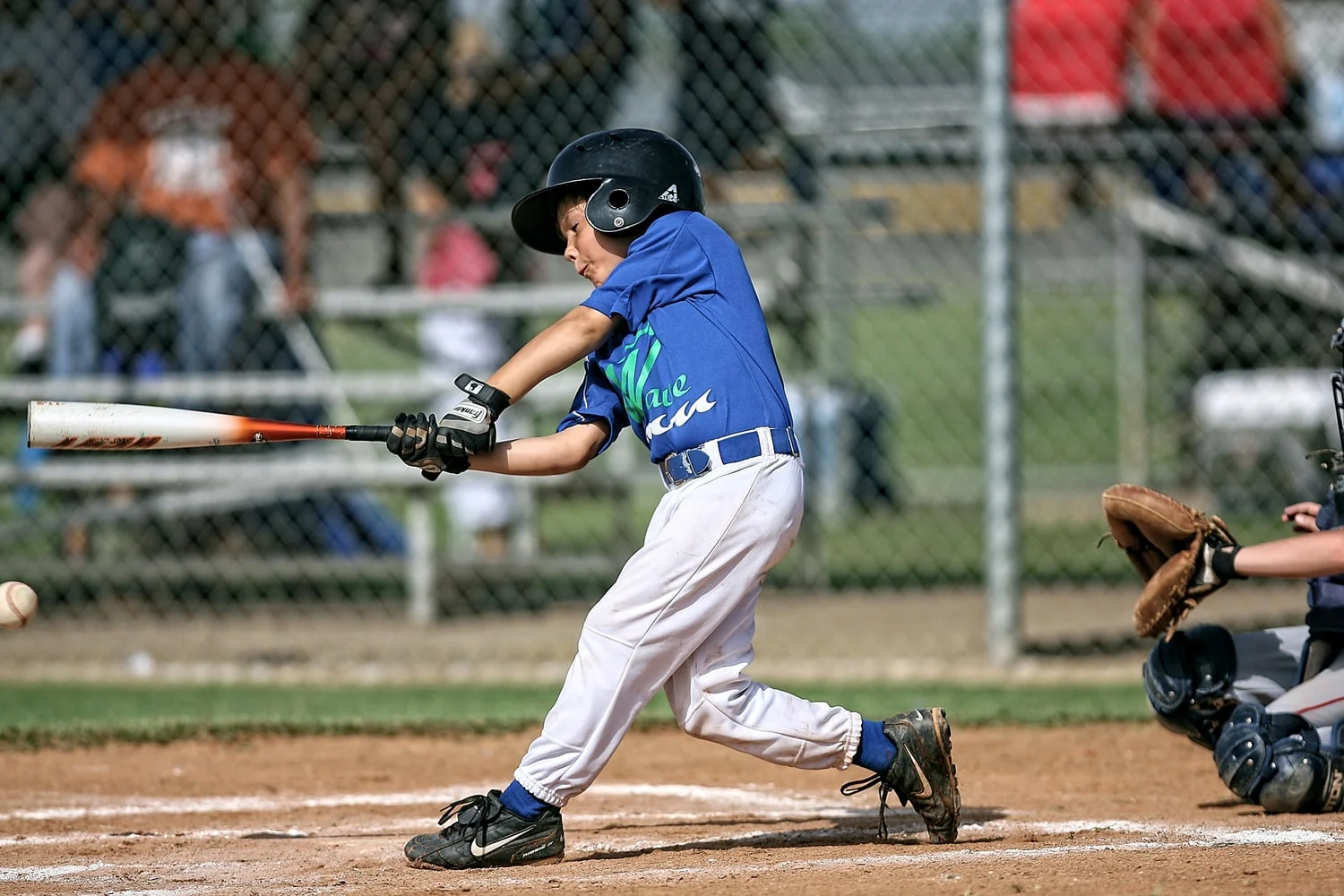 a youth baseball player getting a hit during a game