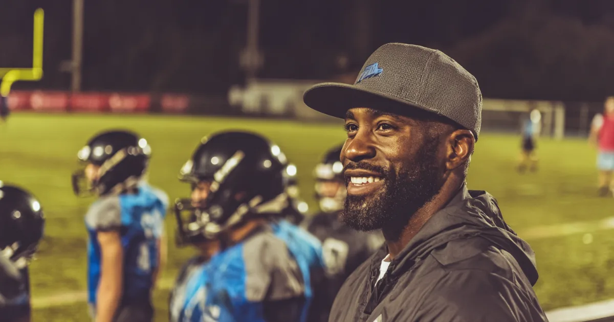 Youth sports coach and administrator working with youth athletes