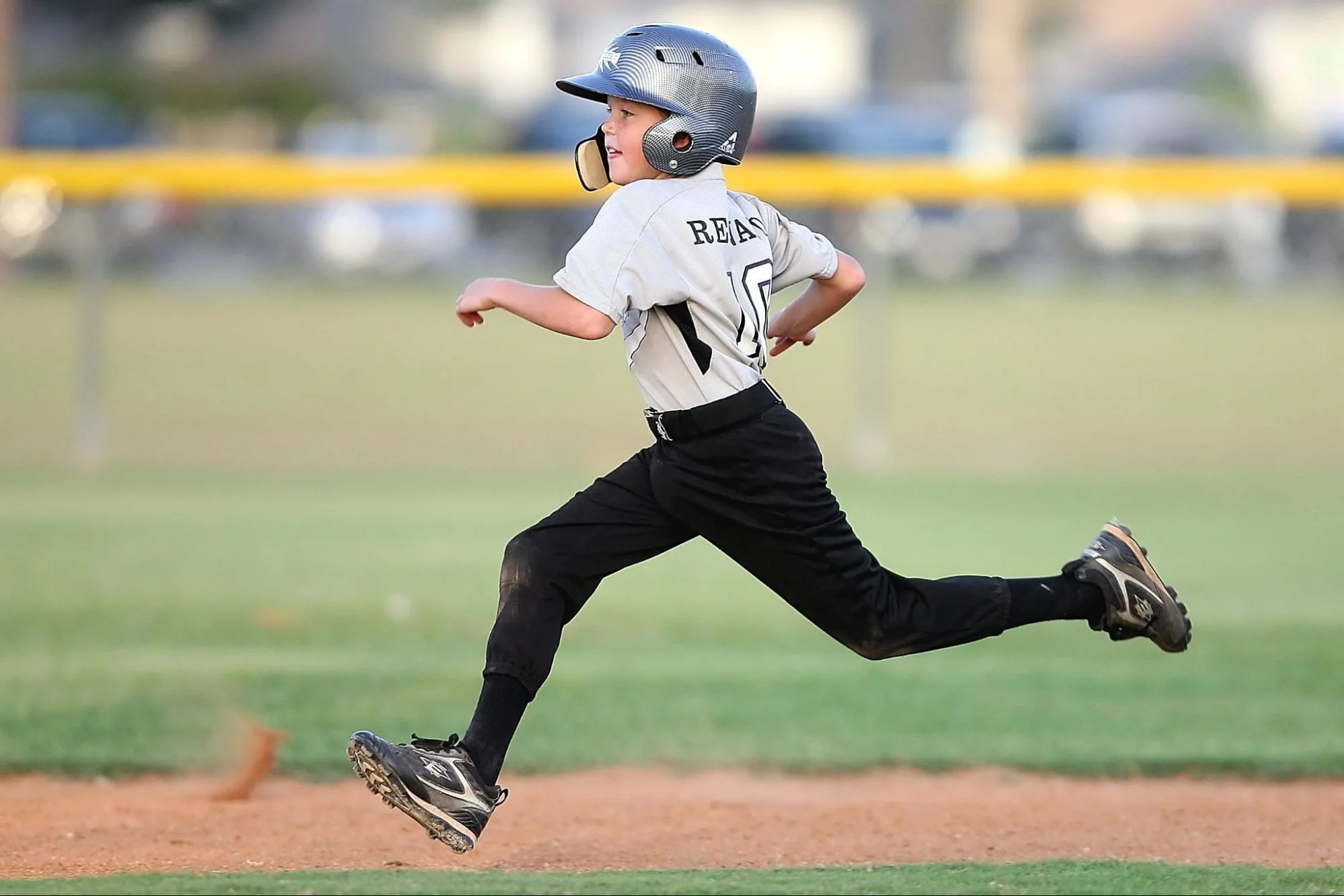 a youth baseball player running the bases