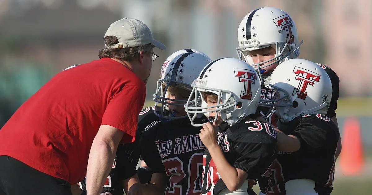 a youth football coach managing his team