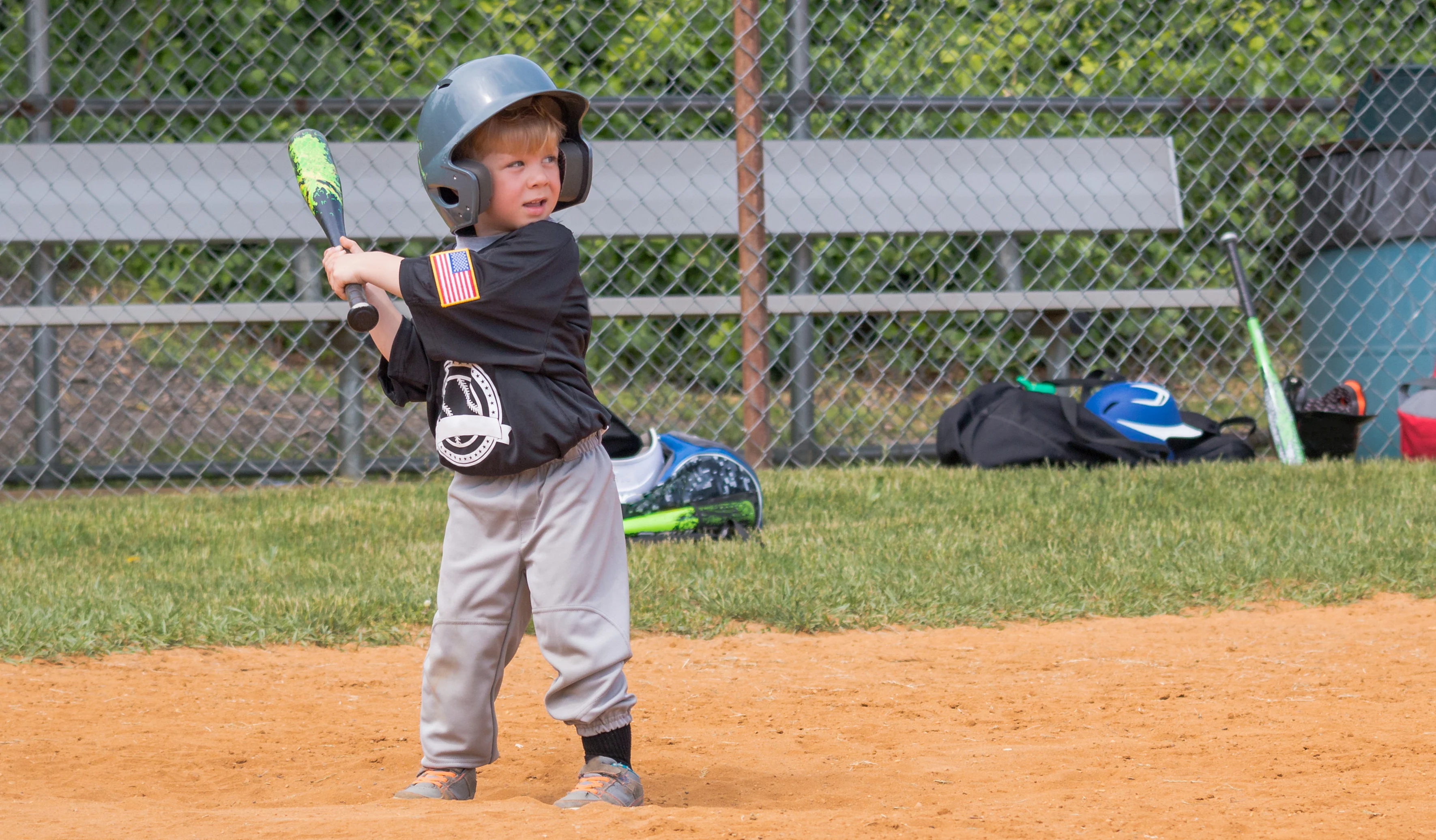 a young baseball player getting ready to hit the ball