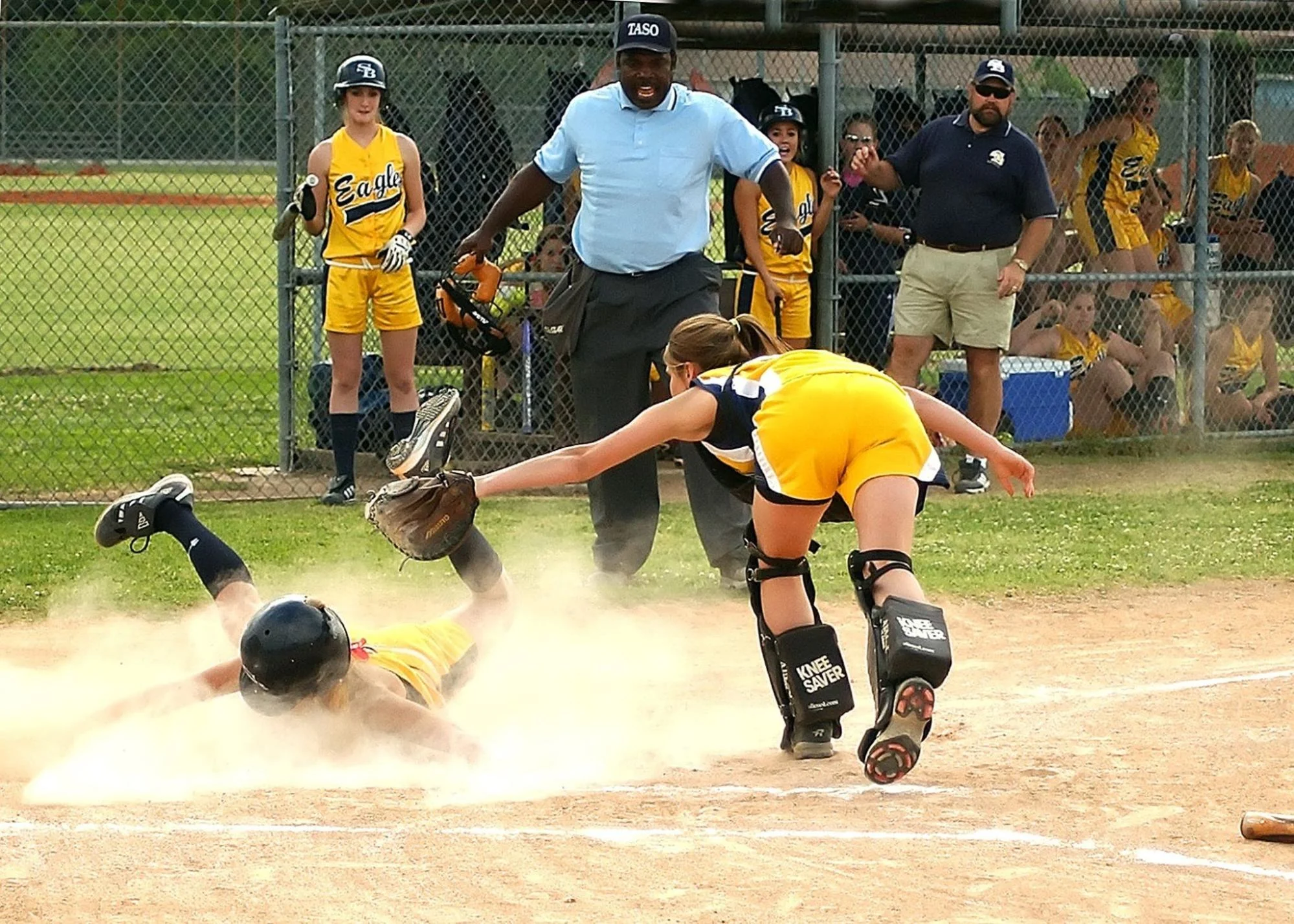 a youth softball play at the plate