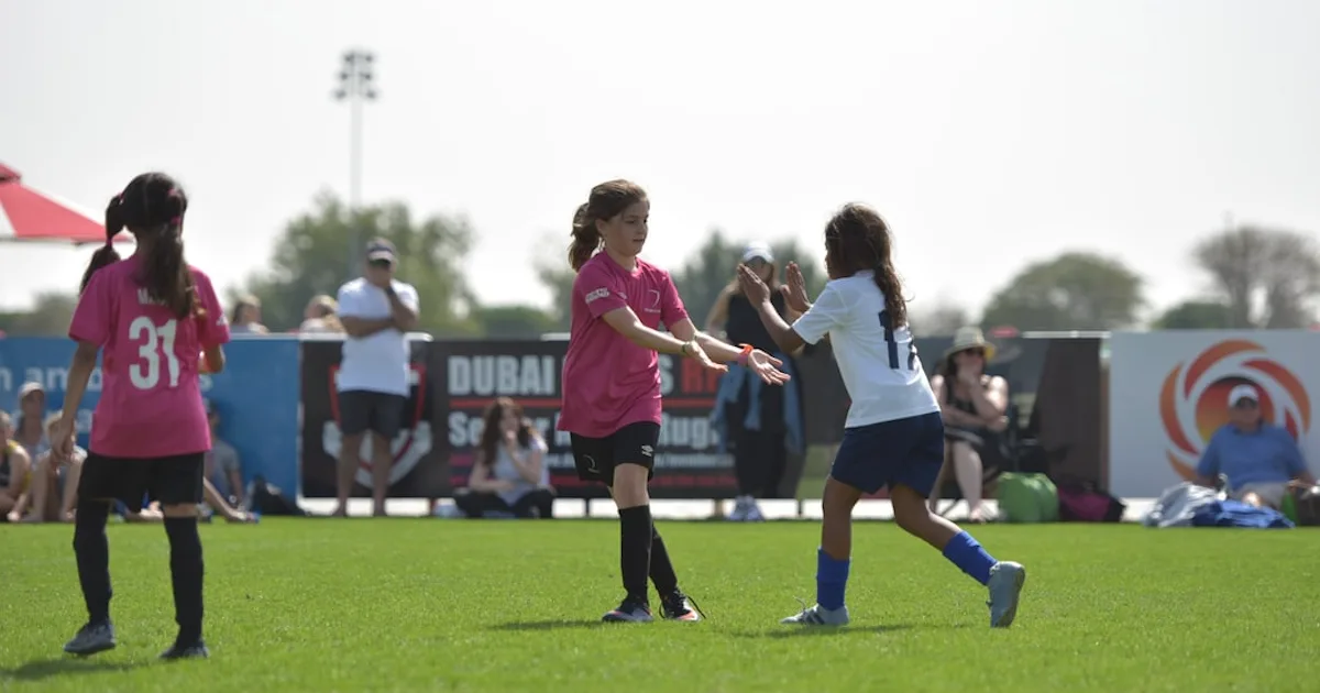 high five on a youth soccer field