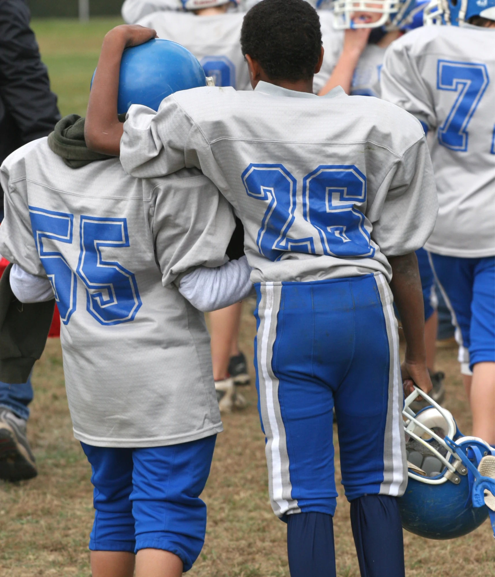 two youth football players bonding after a game