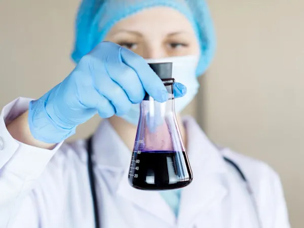 Scientist holding a jar in a lab