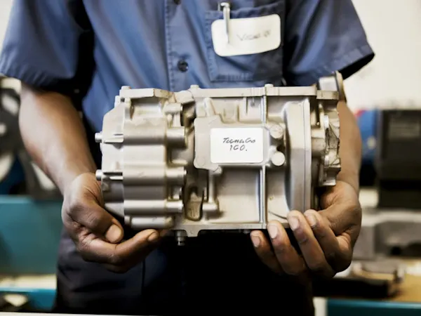 Person holding an engine part