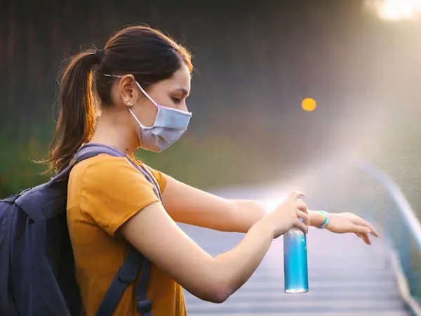 Woman using mosquito repellent