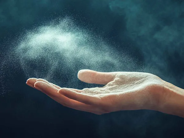 Woman putting talc on hand