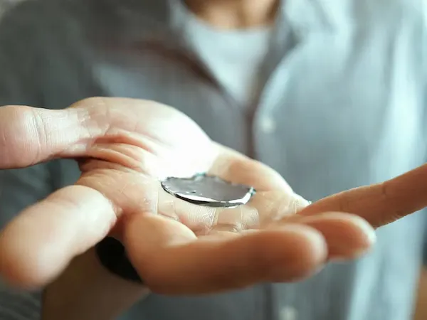 Hand holding mercury metal