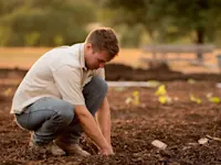 Farmer planting seeds in soil