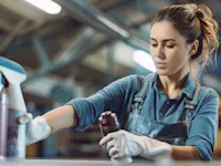 Woman spraying adhesives